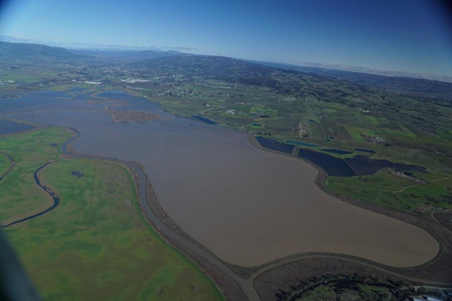 Aerial photograph taken during March 2019, when levees broke at Camp 4 Ranch and throughout the Sonoma Creek Baylands, causing widespread flooding. Levee breaks and flooding are typical under storm conditions in this region.  