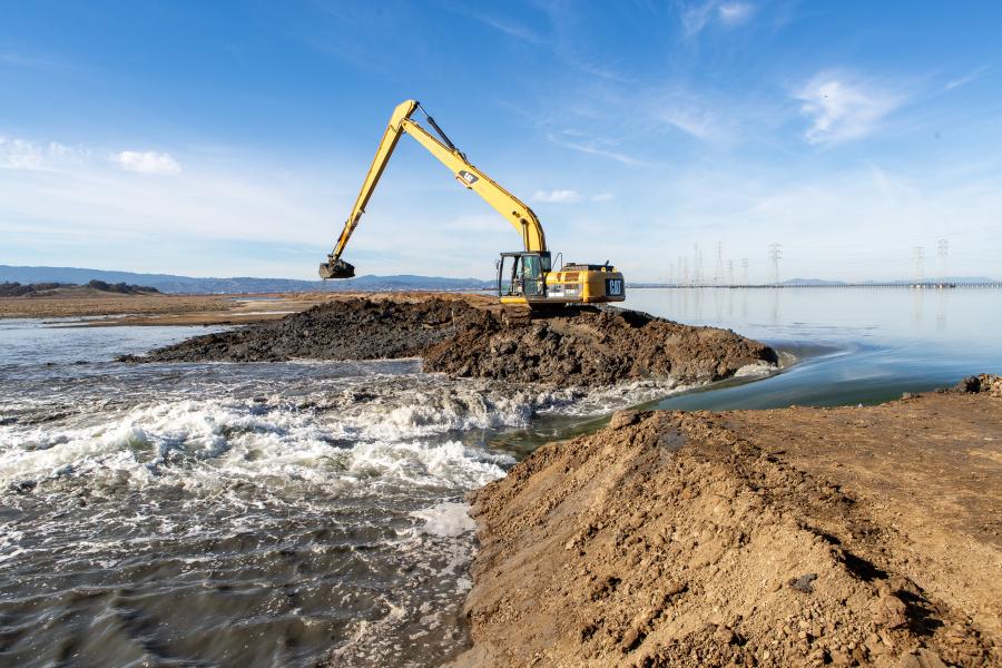Excavator breaches the bayside levee at Ravenswood R4 pond